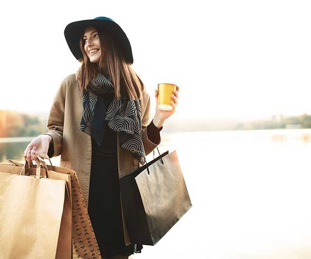 Shopping bag and coffee cup on a table, symbolizing the retail and leisure experience at Park Eight Place